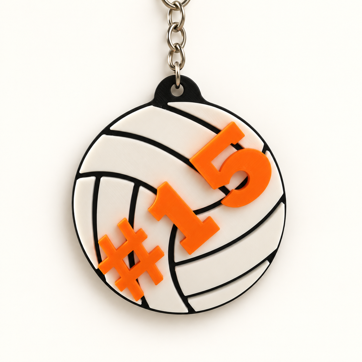 White volleyball keychain with orange jersey number 15